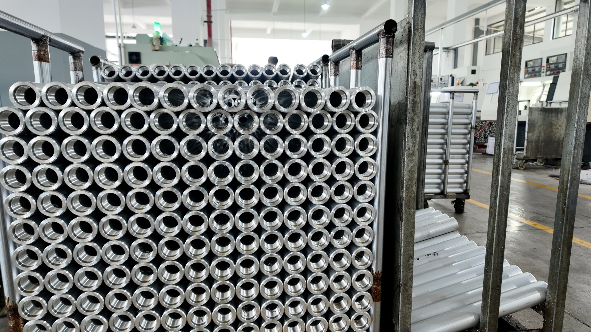 Semi-finished aluminum tubes in staging area